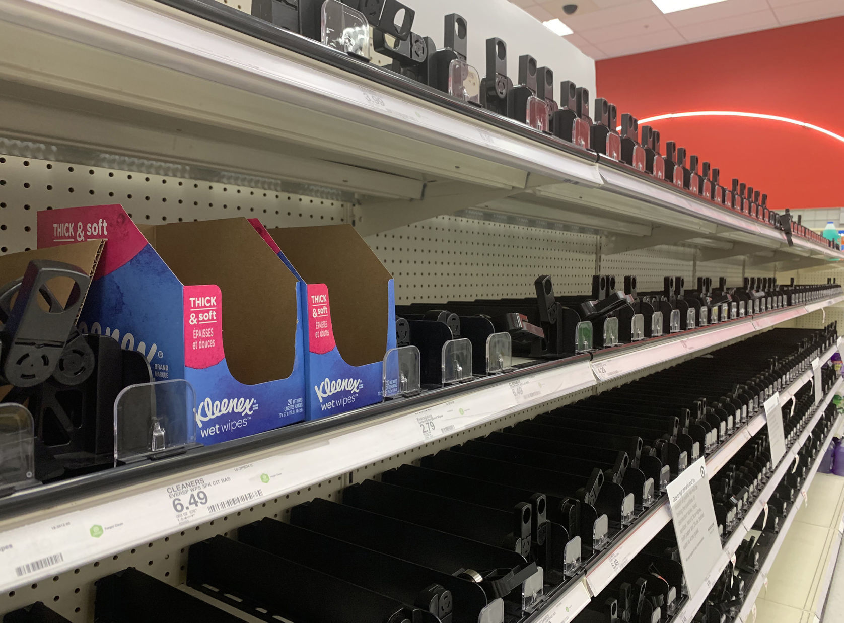 Empty shelves of disinfectatnt wipes, hand sanitizer and toilet paper